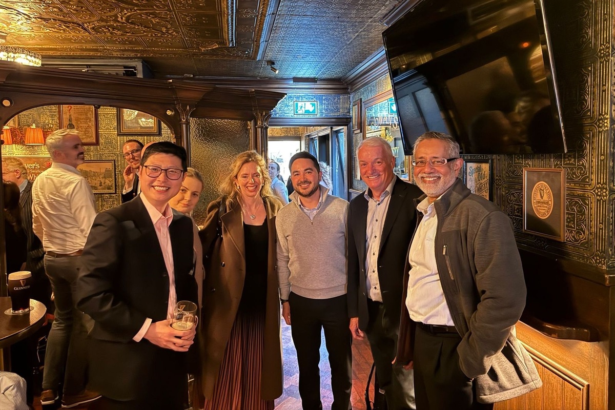 Guests standing at the bar of a Victorian pub