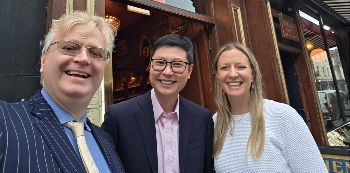 Three people smiling for a photograph in a Dublin pub