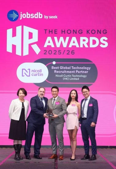 An award presentation on a pink stage