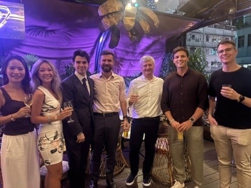 Young professionals in a group under purple light